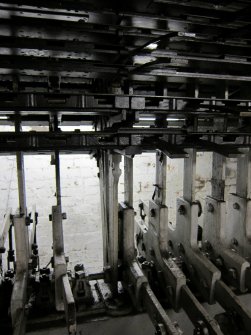 Interior. Locking Room. Vertical Locking Tray and levers, track side. Detail.  The [sword] tappets are visible at the top of the locking tray. The Locking Tray contains locking bars which connect to dogs to other dogs allowing locking or movement of the tappets (in turn connected to the levers operated from the first floor of the signal box). This is a Glasgow 'new style' design of vertical locking tray.
