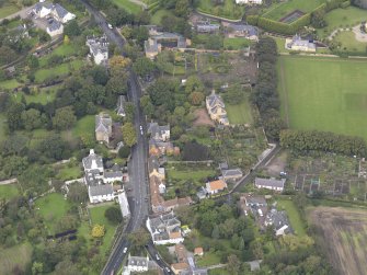 General oblique aerial view of Inveresk Village Road centred on the Manor House, looking to the NW.
