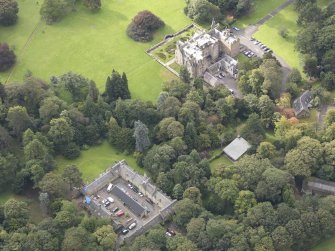 General oblique aerial view of Carberry Tower with adjacent stable block, looking to the SW.