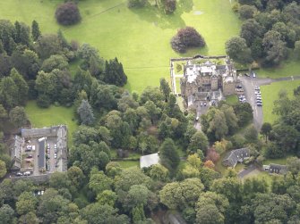 General oblique aerial view of Carberry Tower with adjacent stable block, looking to the SSE.
