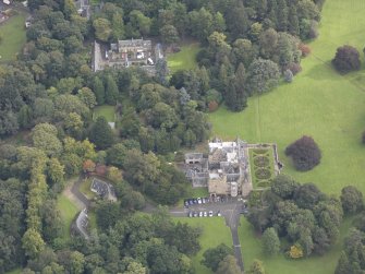 General oblique aerial view of Carberry Tower with adjacent stable block and Italian Garden, looking to the E.