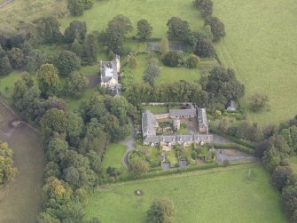 General oblique aerial view of Keith Marischal Country House with adjacent stables, looking to the NE.