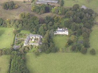 General oblique aerial view of Keith Marischal Country House with adjacent stables, looking to the NW.