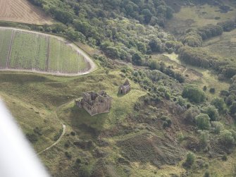 General oblique aerial view of Crichton Castle with The Slaughter House adjacent, looking to the SE.