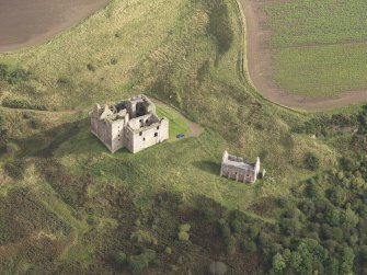 General oblique aerial view of Crichton Castle with The Slaughter House adjacent, looking to the NE.