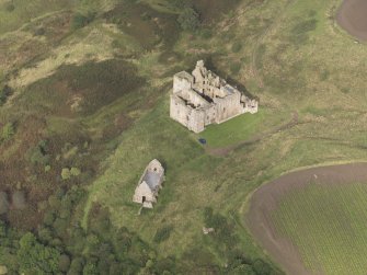 General oblique aerial view of Crichton Castle with The Slaughter House adjacent, looking to the NNW.