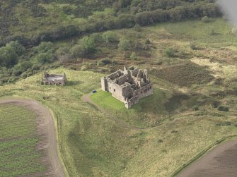 General oblique aerial view of Crichton Castle with The Slaughter House adjacent, looking to the W.