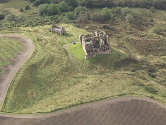General oblique aerial view of Crichton Castle with The Slaughter House adjacent, looking to the WSW.