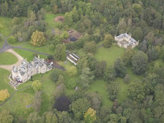 General oblique aerial view of Vogrie House with adjacent stables, looking to the WNW.