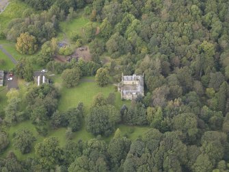 General oblique aerial view of Vogrie House with adjacent stables, looking to the NW.