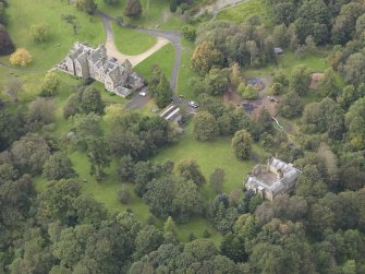 General oblique aerial view of Vogrie House with adjacent stables, looking to the W.