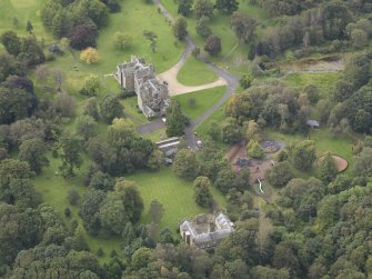 General oblique aerial view of Vogrie House with adjacent stables, looking to the SW.