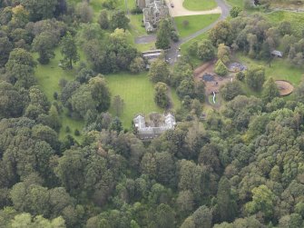 General oblique aerial view of Vogrie House with adjacent stables, looking to the SW.