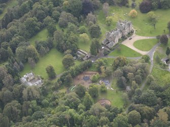 General oblique aerial view of Vogrie House with adjacent stables, looking to the S.