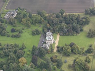 General oblique aerial view of Preston Hall with adjacent stables, looking to the E.