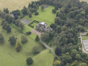 General oblique aerial view of Oxenfoord Castle with adjacent viaduct, looking to the NE.