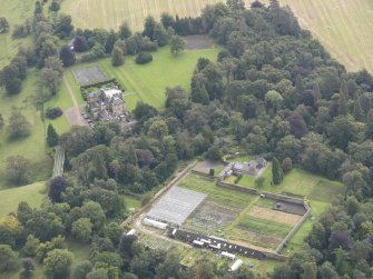 General oblique aerial view of Oxenfoord Castle with adjacent viaduct and walled garden, looking to the SSE.