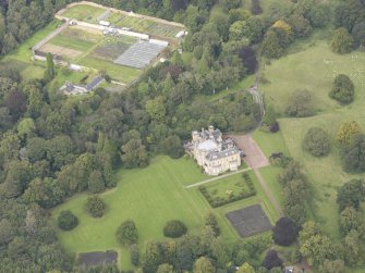 General oblique aerial view of Oxenfoord Castle with adjacent walled garden, looking to the NNW.