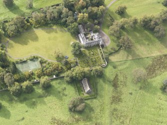 General oblique aerial view of Roseberry House with adjacent Episcopal Chapel, looking to the SW.