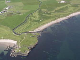 Oblique aerial view of Dunaverty Golf Course, Southend and Brunerican Bay, looking NNE.