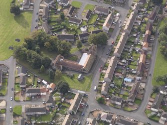 Oblique aerial view of Stenhouse and Carron Parish Church, taken from the E.