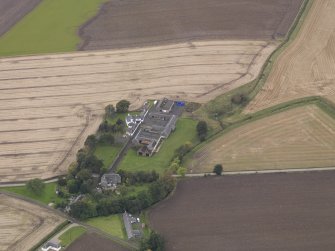 Oblique aerial view of Benvie Farm Buildings and Church, taken from the NE.