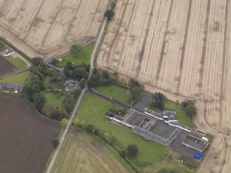 Oblique aerial view of Benvie Church and farm buildings, taken from the N.