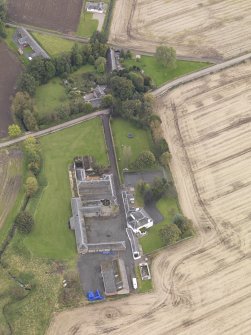Oblique aerial view of Benvie Farm Buildings and Church, taken from the NNW.