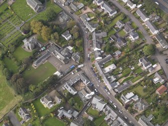 Oblique aerial view of Longforgan Main Street, taken from the SE.
