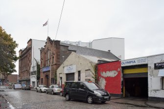 General view from east showing surrounding buildings.