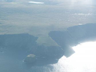 General oblique aerial view of the promontory fort at Busta Pund, Fetlar, looking SW.