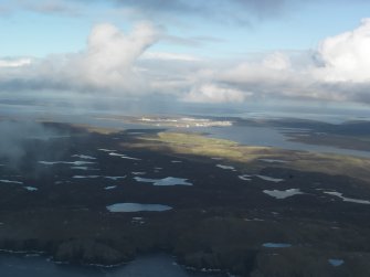 General oblique aerial view of Hill of Heodale with Sullom Voe in the distance, looking NE.