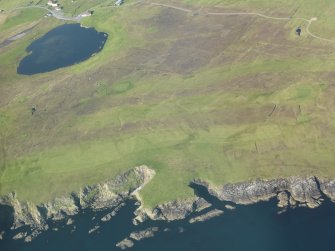 Oblique aerial view of Whalsay Golf Course with the promontory enclosure in the foreground, looking NW.