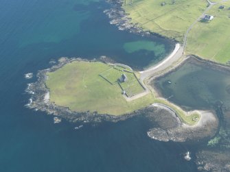 Oblique aerial view of Whalsay Kirk, Kirk Ness, looking SE.