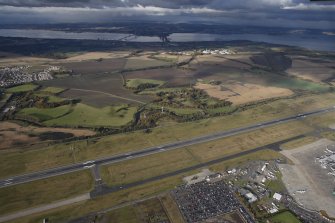 General oblique aerial view of Carlowrie Country House with the runway in the foreground and the Bridges in the distance, looking N.