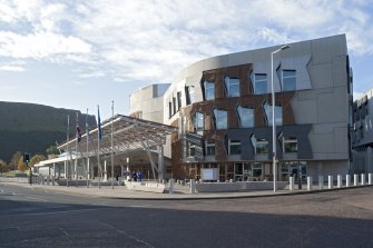 View looking south west across the corner of Queen's Drive and Canongate to the Media Tower, main entrance and canopies of the Scottish Parliament