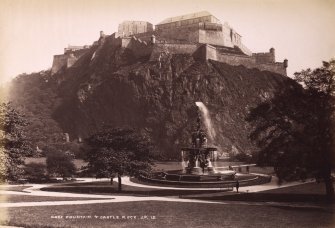 Edinburgh, Princes Street Gardens. View taken of the castle from the Gardens. Titled: 'ROSS FOUNTAIN & CASTLE ROCK J.P.13.'
PHOTOGRAPH ALBUM No.195:  Photographs by G W Wilson & Co.
Blue leatherbound album