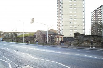 General view of the perimeter walls of the former Maryhill Barracks site on Maryhill Road including gate piers and gate house, taken from the north.