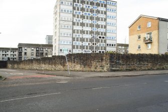 General view of the perimeter walls of the former Maryhill Barracks site, taken at the junction of Contin Place and Garioch Road from the east.