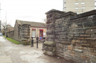 Detail of the gate piers and gatehouse within the perimeter walls of the former Maryhill Barracks site.