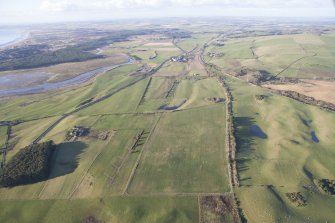 Oblique aerial view of the archaeological evaluation trenches in advance of the A75 Dunragit Bypass construction.