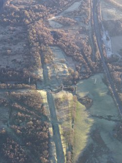 Oblique aerial view of Rough Castle Roman Fort and the Antonine Wall, looking ENE.