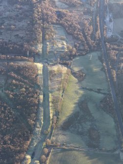 Oblique aerial view of Rough Castle Roman Fort and the Antonine Wall, looking ENE.