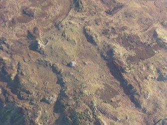 Oblique aerial view centred on Green House Bridge cairn, the hut-circles and small cairns, looking ESE.