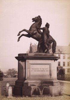 View of statue of man with horse, St Andrews Square, Edinburgh. Now in the courtyard of City Chambers. 
Titled: 'Alexander & Bucephalus J.P.'
PHOTOGRAPH ALBUM No. 195: George Washington Wilson Album, p.133.