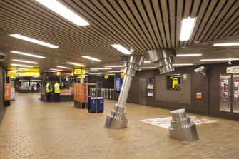 Interior. View along concourse of St Enoch subway station, including sculpture 'Chthonic Columns' by Mark Firth (1996)