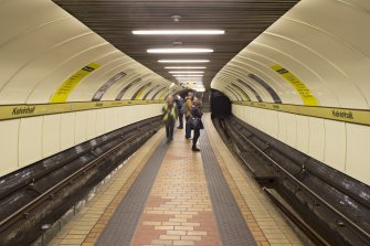 Interior. View looking along the island platform and tracks of Kelvinhall subway station