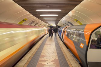 Interior. View looking along island platform of Kelvinhall subway station, with trains at both platforms