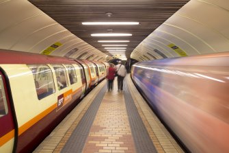 Interior. View looking along island platform of Kelvinhall subway station, with trains at both platforms