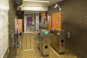 Interior. View looking back into concourse of Kelvinhall subway station, showing turnstiles, ticket office and entrance